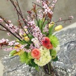 Beautiful floral arrangement made with tulips, cherry blossoms, hydrangeas and ranunculus.